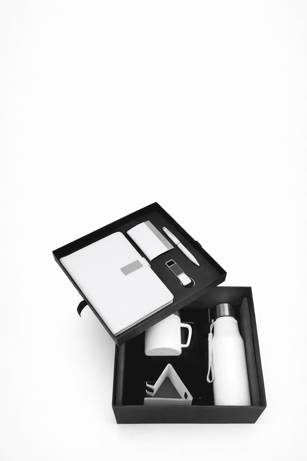 A cozy shop interior displays a variety of candles and accessories. Wooden shelves line the walls, filled with candles, vases, and decorative items. The central wooden table is adorned with an array of colorful dried flowers and various candle options. Large decorative jars and small potted plants add to the rustic aesthetic.
